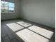 Well-lit bedroom with a bright window and neutral colored tile flooring at 2324 Juniper Berry Dr, Minneola, FL 34715