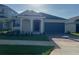 Charming single-story home with a well-maintained lawn and a two-car garage at 2324 Juniper Berry Dr, Minneola, FL 34715