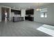 Open-concept kitchen featuring dark cabinetry, stainless appliances, and island with white quartz countertops at 2324 Juniper Berry Dr, Minneola, FL 34715