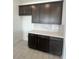 Contemporary kitchen area featuring dark cabinets, white countertops, and modern appliances at 2324 Juniper Berry Dr, Minneola, FL 34715
