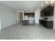 Open concept kitchen with dark cabinetry, large center island, and stainless-steel appliances at 2324 Juniper Berry Dr, Minneola, FL 34715