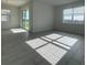 Spacious living room with sliding door access and large window at 2324 Juniper Berry Dr, Minneola, FL 34715