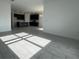 Spacious living room with gray tile floors, flowing into an open-concept kitchen at 2324 Juniper Berry Dr, Minneola, FL 34715