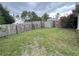 Wide view of a backyard with grass, shed, and wood fence at 2947 Aldrich St, Eustis, FL 32726