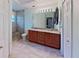 Bathroom featuring a double vanity, a large framed mirror, and a walk-in glass shower at 2947 Aldrich St, Eustis, FL 32726