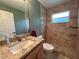 Bathroom featuring a light vanity, toilet, and glass-enclosed shower with neutral-colored tile at 2947 Aldrich St, Eustis, FL 32726