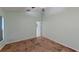 Bright bedroom with neutral paint, tan tile floors, and a ceiling fan offering a calming space at 2947 Aldrich St, Eustis, FL 32726