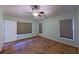 A bedroom with neutral walls, tile flooring, and windows fitted with cellular shades, plus a ceiling fan at 2947 Aldrich St, Eustis, FL 32726