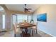 Inviting dining area with a large window, stylish furnishings, and tile flooring at 2947 Aldrich St, Eustis, FL 32726