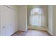 A room with a large window, white blinds, light green walls, and a closet with sliding doors at 2947 Aldrich St, Eustis, FL 32726