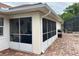 Enclosed sunroom with brick flooring leads to the pool at 2947 Aldrich St, Eustis, FL 32726