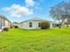 Expansive backyard with manicured lawn and views of neighboring homes at 5317 Butterfly Ct, Leesburg, FL 34748