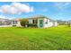 Beautiful home backyard with lush green grass, blue door and blue sky at 5317 Butterfly Ct, Leesburg, FL 34748