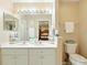 Clean bathroom featuring a double vanity, soft lighting, and coordinated fixtures at 5317 Butterfly Ct, Leesburg, FL 34748