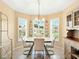 Open dining area featuring decorative plates, natural light, and sleek table set at 5317 Butterfly Ct, Leesburg, FL 34748