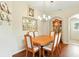 Inviting dining room featuring a wooden table, decorative wall art, and chandelier lighting at 5317 Butterfly Ct, Leesburg, FL 34748