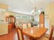 Elegant dining room with hardwood floors, chandelier lighting, and open access to living area at 5317 Butterfly Ct, Leesburg, FL 34748