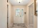 Welcoming foyer with a decorative glass front door, tile flooring, and neutral wall paint at 5317 Butterfly Ct, Leesburg, FL 34748