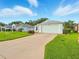 Charming single-story home with a two-car garage, well-maintained lawn, and a concrete driveway at 5317 Butterfly Ct, Leesburg, FL 34748