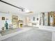 Well-organized two-car garage with shelving, workbench, and a utility sink at 5317 Butterfly Ct, Leesburg, FL 34748