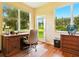 Comfortable home office with warm lighting, wooden furniture, and bright window view at 5317 Butterfly Ct, Leesburg, FL 34748