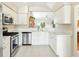 Modern kitchen with white cabinets, stainless steel appliances, and a convenient layout at 5317 Butterfly Ct, Leesburg, FL 34748