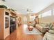 Spacious living room with hardwood floors, neutral paint, and open layout to dining area at 5317 Butterfly Ct, Leesburg, FL 34748