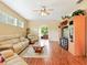 Bright living room with hardwood floors, large windows, and comfortable seating arrangement at 5317 Butterfly Ct, Leesburg, FL 34748