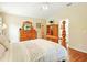 Comfortable primary bedroom with hardwood floors, wooden furniture, and a cozy atmosphere at 5317 Butterfly Ct, Leesburg, FL 34748
