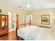 Bright primary bedroom featuring ensuite bathroom and comfortable seating area at 5317 Butterfly Ct, Leesburg, FL 34748