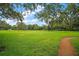 Well-maintained lawn, mature trees and a walking path at 9335 Silver Lake Dr, Leesburg, FL 34788