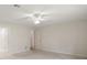 Bright, carpeted bedroom with two entry doors and a ceiling fan at 9335 Silver Lake Dr, Leesburg, FL 34788