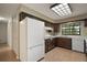 Traditional kitchen featuring ample cabinet space, appliances, and tile flooring at 9335 Silver Lake Dr, Leesburg, FL 34788