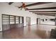 Spacious living room with exposed beams, built-in shelving, and tiled floor at 9335 Silver Lake Dr, Leesburg, FL 34788