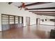 Spacious living room with exposed beams, built-in shelving, and tiled floor at 9335 Silver Lake Dr, Leesburg, FL 34788