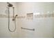 Shower area featuring tile surround, toiletry niche, and grab bar at 9335 Silver Lake Dr, Leesburg, FL 34788