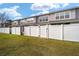 Fenced-in backyard with a lush green lawn, providing privacy and outdoor space for townhome residents at 4904 Sw 45Th St, Ocala, FL 34474