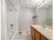 Bathroom features shower-tub combo, wooden vanity, and neutral tile flooring at 4904 Sw 45Th St, Ocala, FL 34474