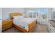 Bright bedroom with light wood furniture set and lots of natural light from the large window at 4904 Sw 45Th St, Ocala, FL 34474