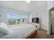 Cozy bedroom featuring a large window, television, and access to a closet and laundry area at 4904 Sw 45Th St, Ocala, FL 34474