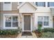 Inviting townhouse entrance with neat landscaping, neutral tones, and a well-kept walkway at 4904 Sw 45Th St, Ocala, FL 34474