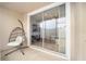 Covered patio with hanging chair leading to a sunny backyard with sliding glass doors at 4904 Sw 45Th St, Ocala, FL 34474
