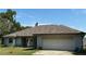 Charming single-story home featuring an attached two-car garage and neutral paint at 1801 Ne 77Th St, Ocala, FL 34479