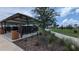 Community mailboxes under a shelter with landscaping and walking path at 2290 Raven Ridge Rd, Minneola, FL 34715