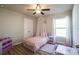 Bedroom featuring a ceiling fan, wood-look floors, and a window at 9200 Se 48Th Court Rd, Ocala, FL 34480