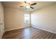 Bedroom featuring wood-look flooring, ceiling fan, a window, and neutral paint at 9200 Se 48Th Court Rd, Ocala, FL 34480