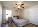 Bedroom with a ceiling fan, wood-look floors, and a window at 9200 Se 48Th Court Rd, Ocala, FL 34480