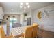 Bright dining area featuring a stylish chandelier and view of the modern kitchen and outdoor space at 9200 Se 48Th Court Rd, Ocala, FL 34480