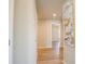 Hallway featuring neutral paint, wood-look flooring, and recessed lighting; artwork hangs on the wall at 9200 Se 48Th Court Rd, Ocala, FL 34480