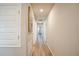 Hallway features wood-look flooring, neutral paint, recessed lighting, and artwork at 9200 Se 48Th Court Rd, Ocala, FL 34480